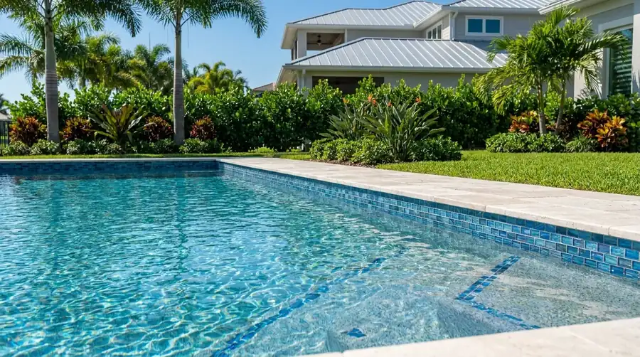 Freshly resurfaced pool with Pebble finish and glass tile in Naples, FL